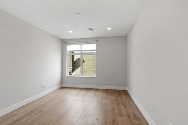 spare room featuring recessed lighting, baseboards, light wood-style floors, and visible vents
