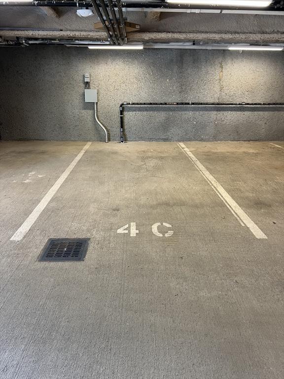 view of vehicle parking featuring visible vents and a parking deck
