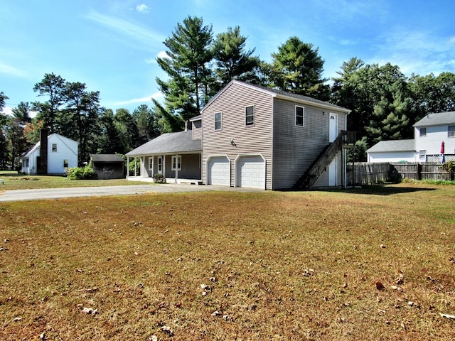 view of front of home with a garage and a front lawn