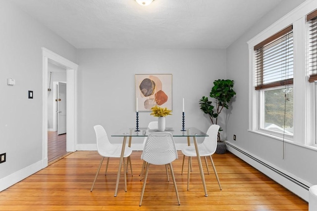 253 Sycamore St Unit 1, Watertown, MA 02472 - dining room featuring a baseboard heating unit, light wood finished floors, healthy amount of natural light, and baseboards