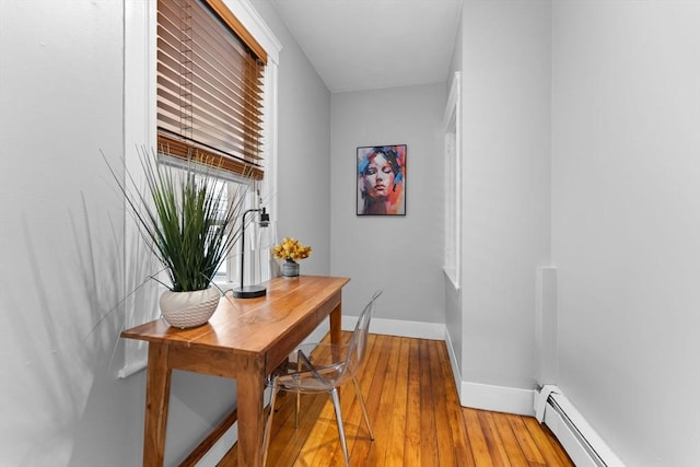 253 Sycamore St Unit 1, Watertown, MA 02472 - hall featuring a baseboard heating unit, baseboards, and light wood-style flooring