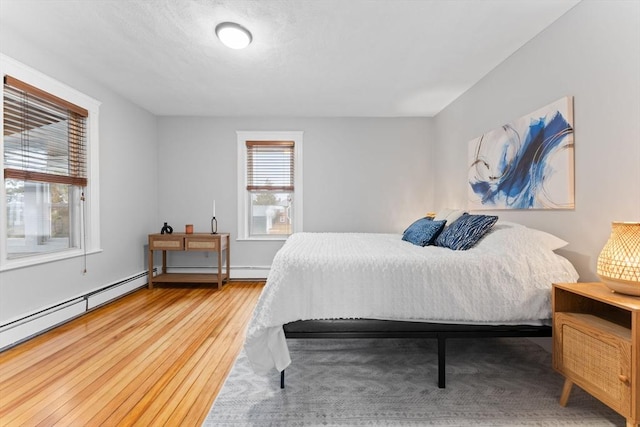 253 Sycamore St Unit 1, Watertown, MA 02472 - bedroom with wood finished floors and baseboard heating