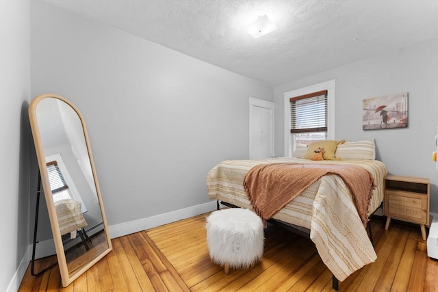 253 Sycamore St Unit 1, Watertown, MA 02472 - bedroom featuring baseboards and hardwood / wood-style floors