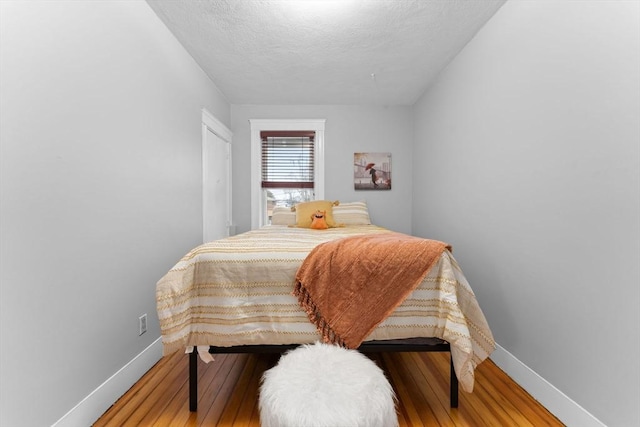 253 Sycamore St Unit 1, Watertown, MA 02472 - bedroom featuring baseboards, hardwood / wood-style floors, and a textured ceiling