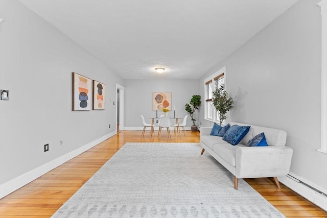 253 Sycamore St Unit 1, Watertown, MA 02472 - sitting room with light wood finished floors, a baseboard radiator, and baseboards