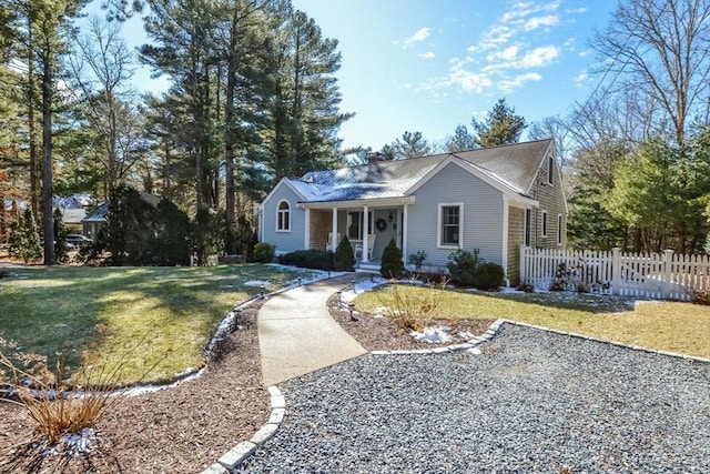 ranch-style house with a front lawn, fence, and a chimney