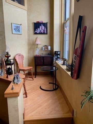 living area with a healthy amount of sunlight and hardwood / wood-style floors