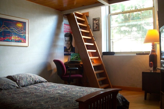 bedroom with hardwood / wood-style flooring and wooden ceiling