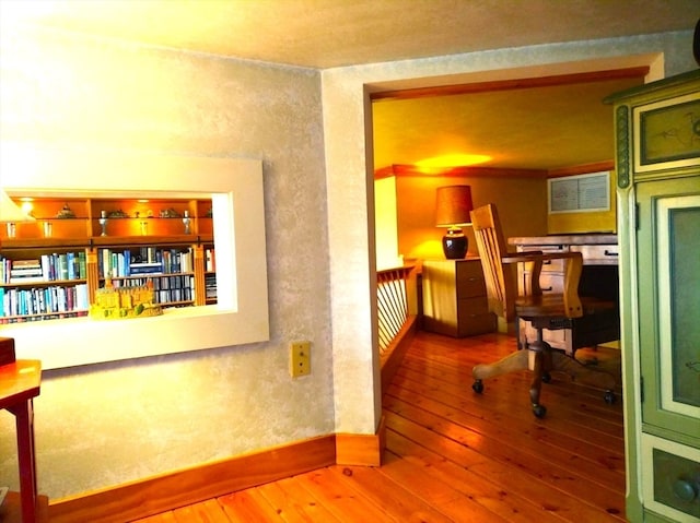 corridor with hardwood / wood-style floors