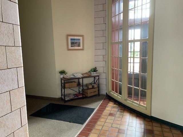 doorway to outside with tile patterned flooring