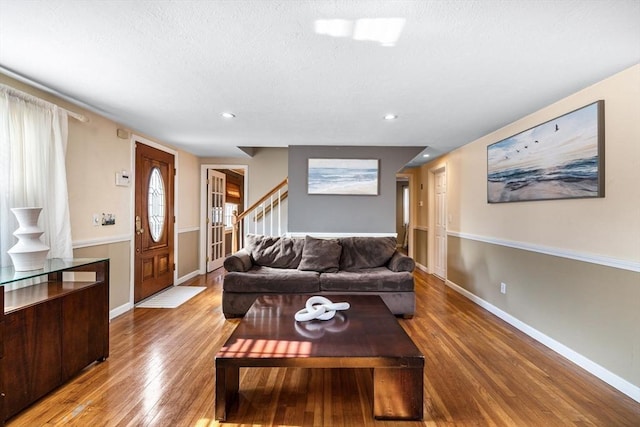 living room featuring light wood finished floors, recessed lighting, stairway, and baseboards