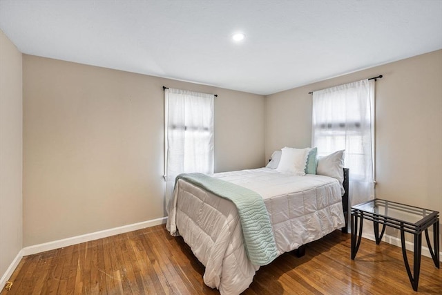 bedroom featuring hardwood / wood-style flooring and baseboards