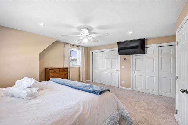 bedroom with recessed lighting, a ceiling fan, two closets, and carpet floors