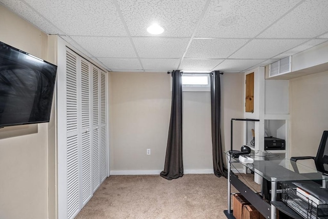 office area with a paneled ceiling, visible vents, light carpet, and baseboards