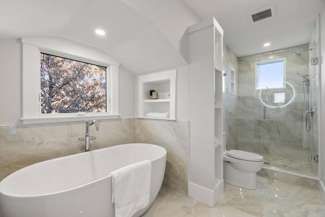 bathroom with toilet, tile walls, independent shower and bath, and vaulted ceiling