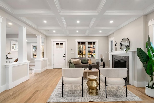 living room with coffered ceiling, light wood-type flooring, ornamental molding, beam ceiling, and decorative columns