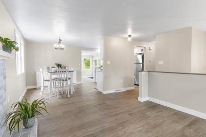 537 S River St, Marshfield, MA 02050 - dining space featuring baseboards, wood finished floors, a chandelier, and a fireplace