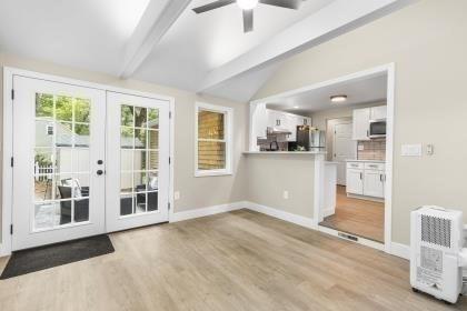 537 S River St, Marshfield, MA 02050 - doorway to outside with french doors, light wood-style flooring, a ceiling fan, and baseboards