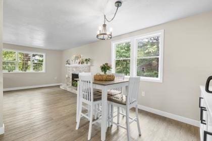 537 S River St, Marshfield, MA 02050 - dining room with baseboards, plenty of natural light, wood finished floors, and a chandelier