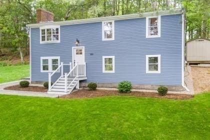 537 S River St, Marshfield, MA 02050 - back of house featuring a lawn, a chimney, and view of scattered trees