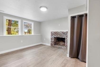 537 S River St, Marshfield, MA 02050 - unfurnished living room with wood finished floors, a fireplace, and baseboards