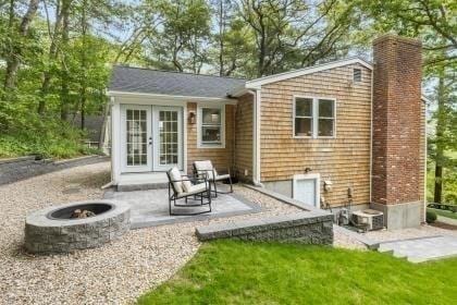 537 S River St, Marshfield, MA 02050 - rear view of property featuring french doors, a fire pit, a chimney, and a patio area