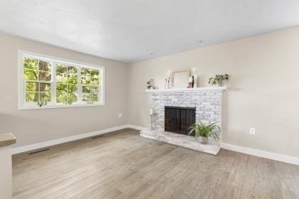 537 S River St, Marshfield, MA 02050 - unfurnished living room with baseboards, a fireplace, and wood finished floors