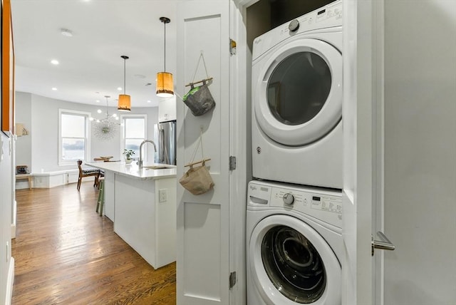1650 Columbia Rd Unit 3, Boston, MA 02127 - laundry room featuring stacked washer / drying machine, dark wood-style floors, and recessed lighting