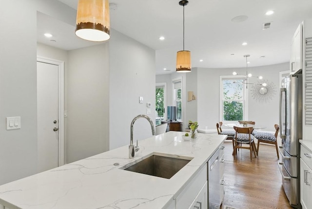 1650 Columbia Rd Unit 3, Boston, MA 02127 - kitchen featuring appliances with stainless steel finishes, plenty of natural light, white cabinets, wood finished floors, and recessed lighting