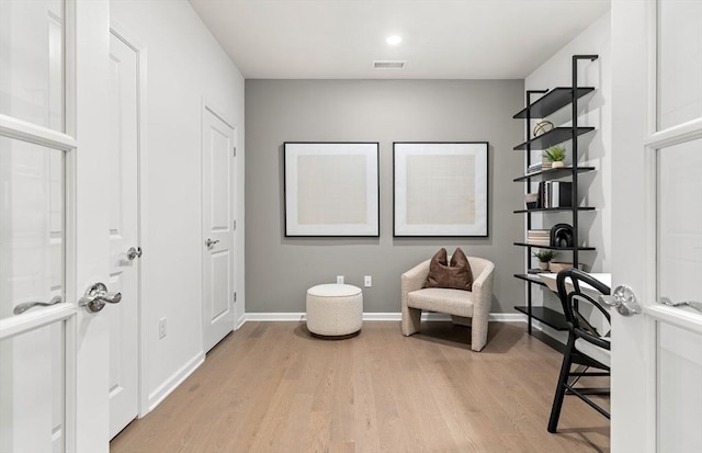 sitting room featuring light wood-style flooring and baseboards