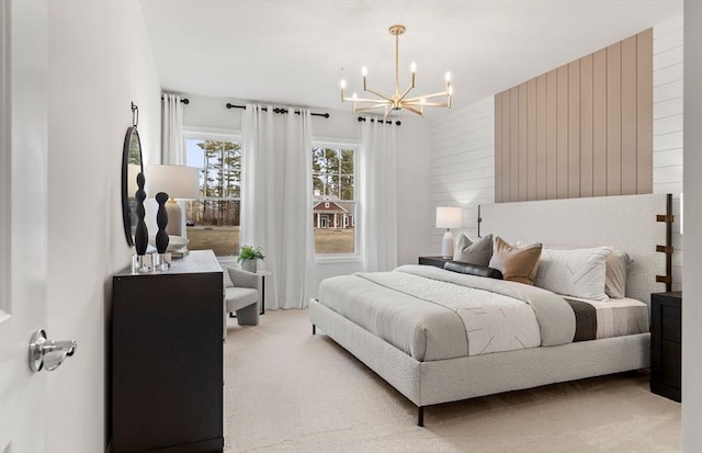 bedroom featuring a chandelier and light carpet