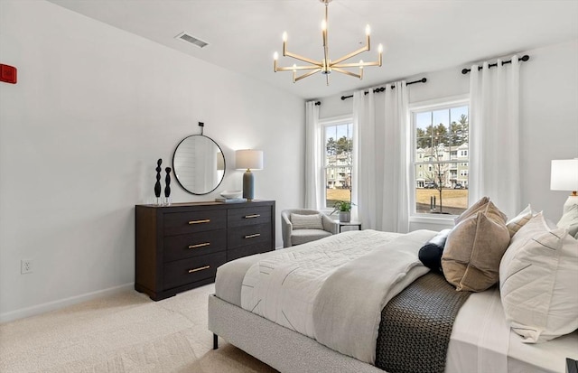 bedroom with a chandelier, baseboards, and light carpet