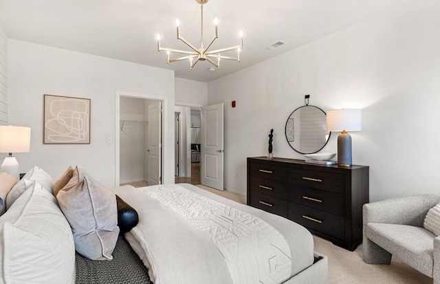 bedroom featuring light colored carpet, a chandelier, a spacious closet, and a closet