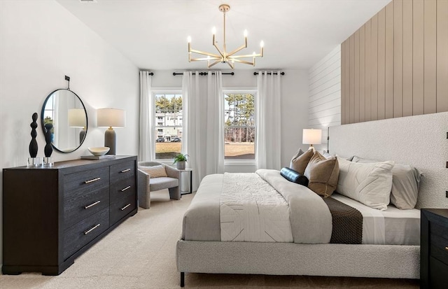 bedroom with a chandelier, light colored carpet, and wooden walls