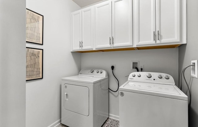 laundry room with cabinet space, washing machine and clothes dryer, and baseboards
