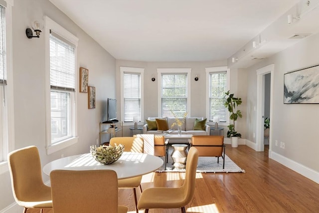 dining area with wood finished floors and baseboards