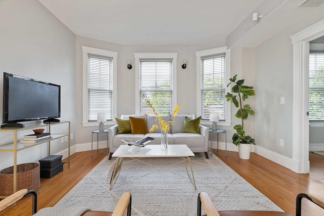 living room with wood finished floors and baseboards