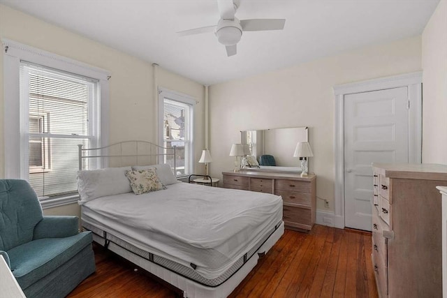 bedroom with a ceiling fan and dark wood finished floors