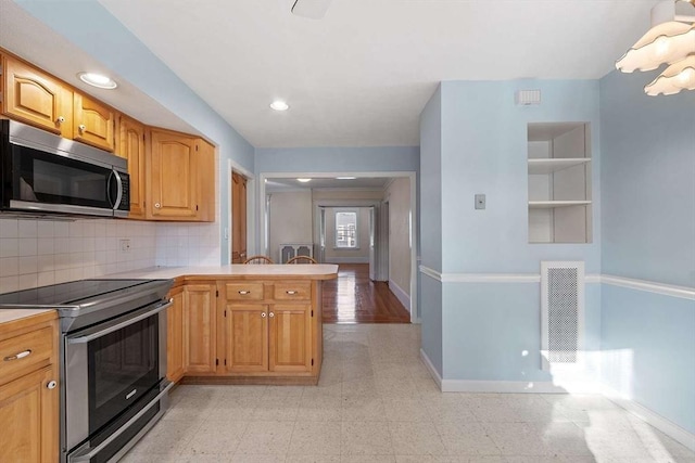 kitchen with baseboards, visible vents, stainless steel appliances, and light countertops