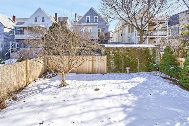 snowy yard with fence