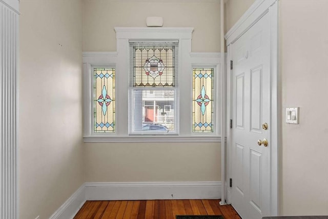 interior space featuring baseboards and wood finished floors