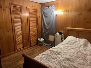 bedroom with wood walls