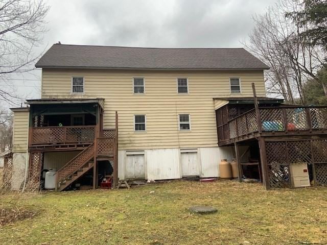 45-47 Middlefield Rd, Chester, MA 01011 - rear view of house with stairs, a wooden deck, a yard, and a sunroom