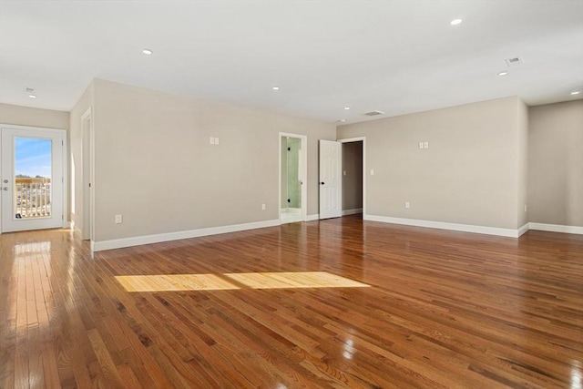 unfurnished room with wood-type flooring