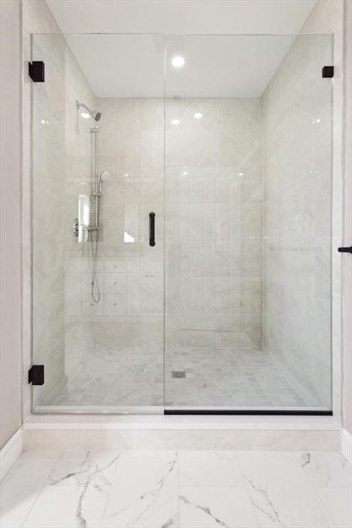 bathroom featuring a shower with door