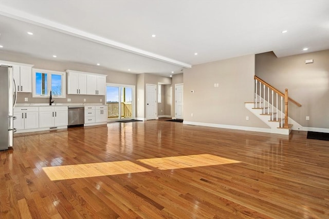 unfurnished living room featuring hardwood / wood-style flooring