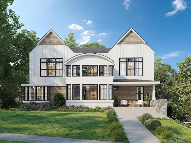 rear view of property featuring a yard, board and batten siding, and a porch