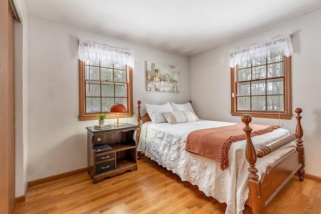 bedroom with light wood-style floors and baseboards