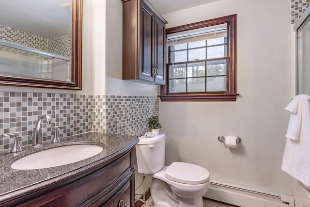 bathroom featuring a baseboard heating unit, toilet, and decorative backsplash