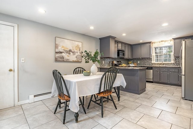 dining room featuring a baseboard radiator, light tile patterned flooring, baseboards, and recessed lighting